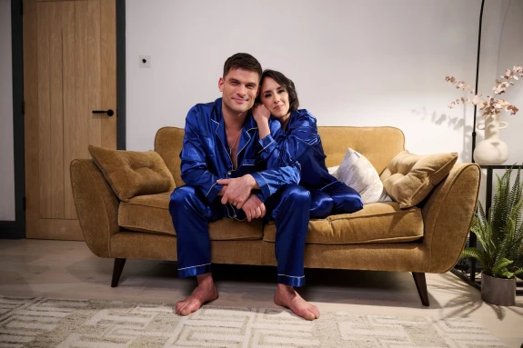Image of ballroom dancers Janette Manrara and Aljaž Škorjanec sitting on a DFS sofa.