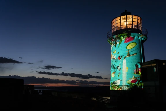Image of Belle Tout lighthouse at night illuminated with artwork.