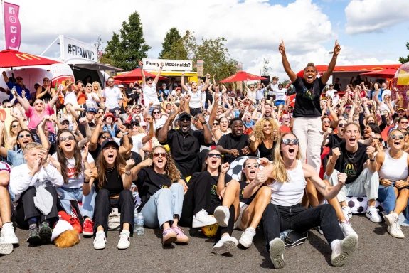 Image of football fans at a McDonald's-hosted screening of a Women's World Cup match.