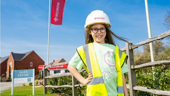 Girl in hard had pictured in front of play area on a Redrow housing development.
